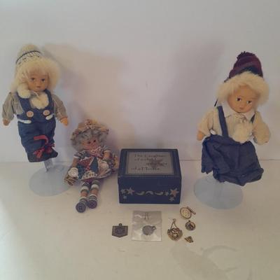 Two collectible dolls with stands, small wooden decorative box and some jewelry
