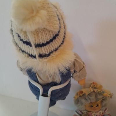 Two collectible dolls with stands, small wooden decorative box and some jewelry