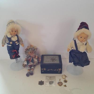 Two collectible dolls with stands, small wooden decorative box and some jewelry