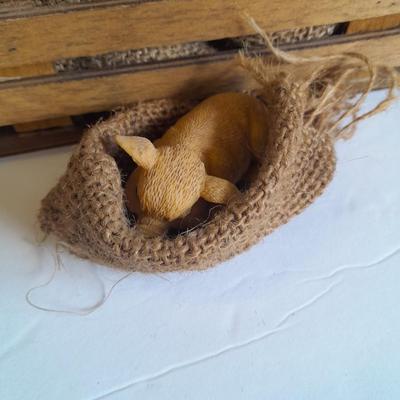 A dozen little pigs in blankets, in a wooden box