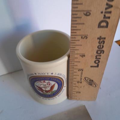U.S.A. Navy clock and mug with sticker and black and white photograph of a ship