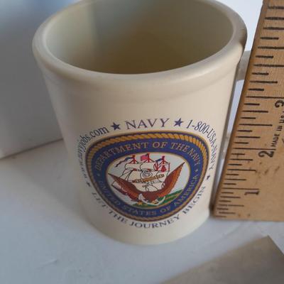 U.S.A. Navy clock and mug with sticker and black and white photograph of a ship