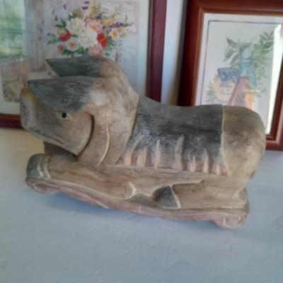 Two framed wall art and a wooden rocking pig decoration