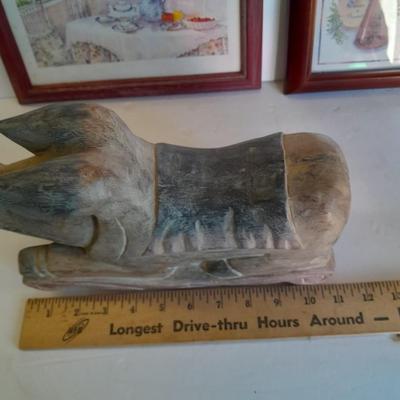 Two framed wall art and a wooden rocking pig decoration
