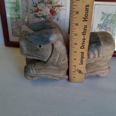 Two framed wall art and a wooden rocking pig decoration