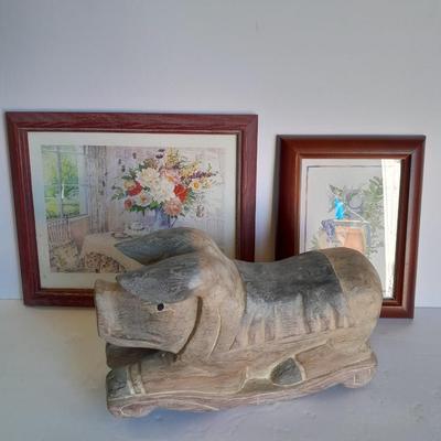 Two framed wall art and a wooden rocking pig decoration