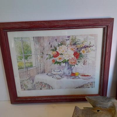 Two framed wall art and a wooden rocking pig decoration