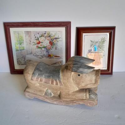 Two framed wall art and a wooden rocking pig decoration