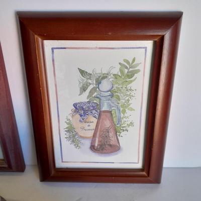 Two framed wall art and a wooden rocking pig decoration