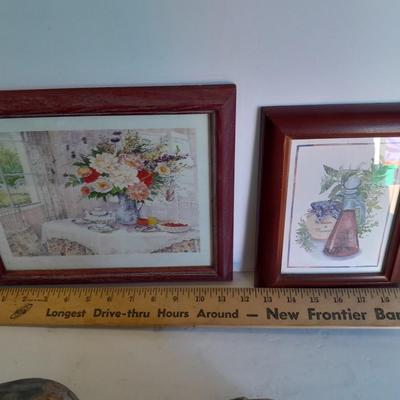 Two framed wall art and a wooden rocking pig decoration