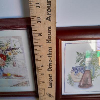 Two framed wall art and a wooden rocking pig decoration