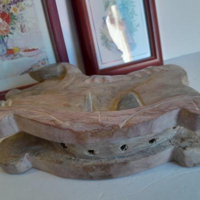 Two framed wall art and a wooden rocking pig decoration
