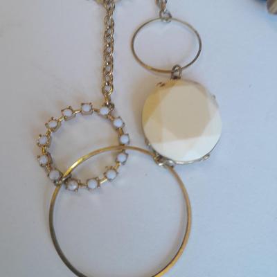 Three fashion necklaces and a gold-colored metal bracelet