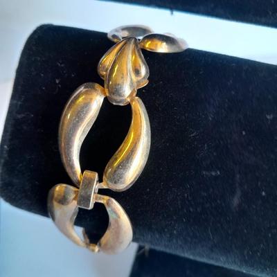 Three fashion necklaces and a gold-colored metal bracelet