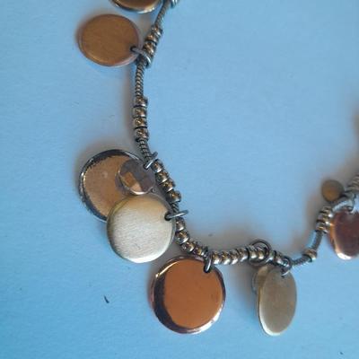 Three fashion necklaces and a gold-colored metal bracelet