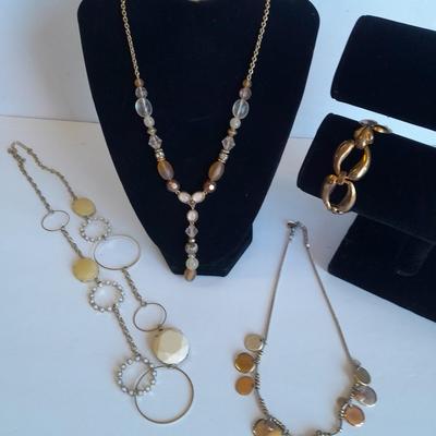 Three fashion necklaces and a gold-colored metal bracelet