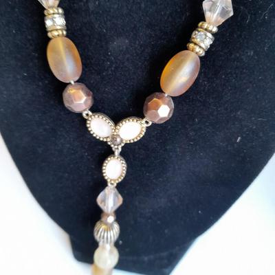 Three fashion necklaces and a gold-colored metal bracelet