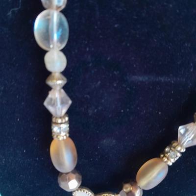 Three fashion necklaces and a gold-colored metal bracelet