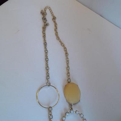 Three fashion necklaces and a gold-colored metal bracelet
