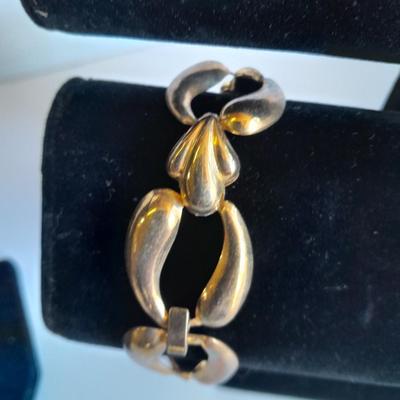 Three fashion necklaces and a gold-colored metal bracelet