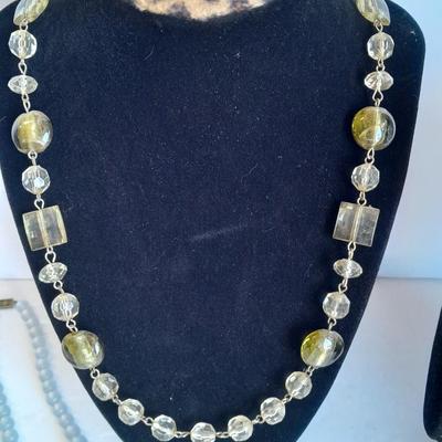 Three beaded necklaces one with matching bracelets