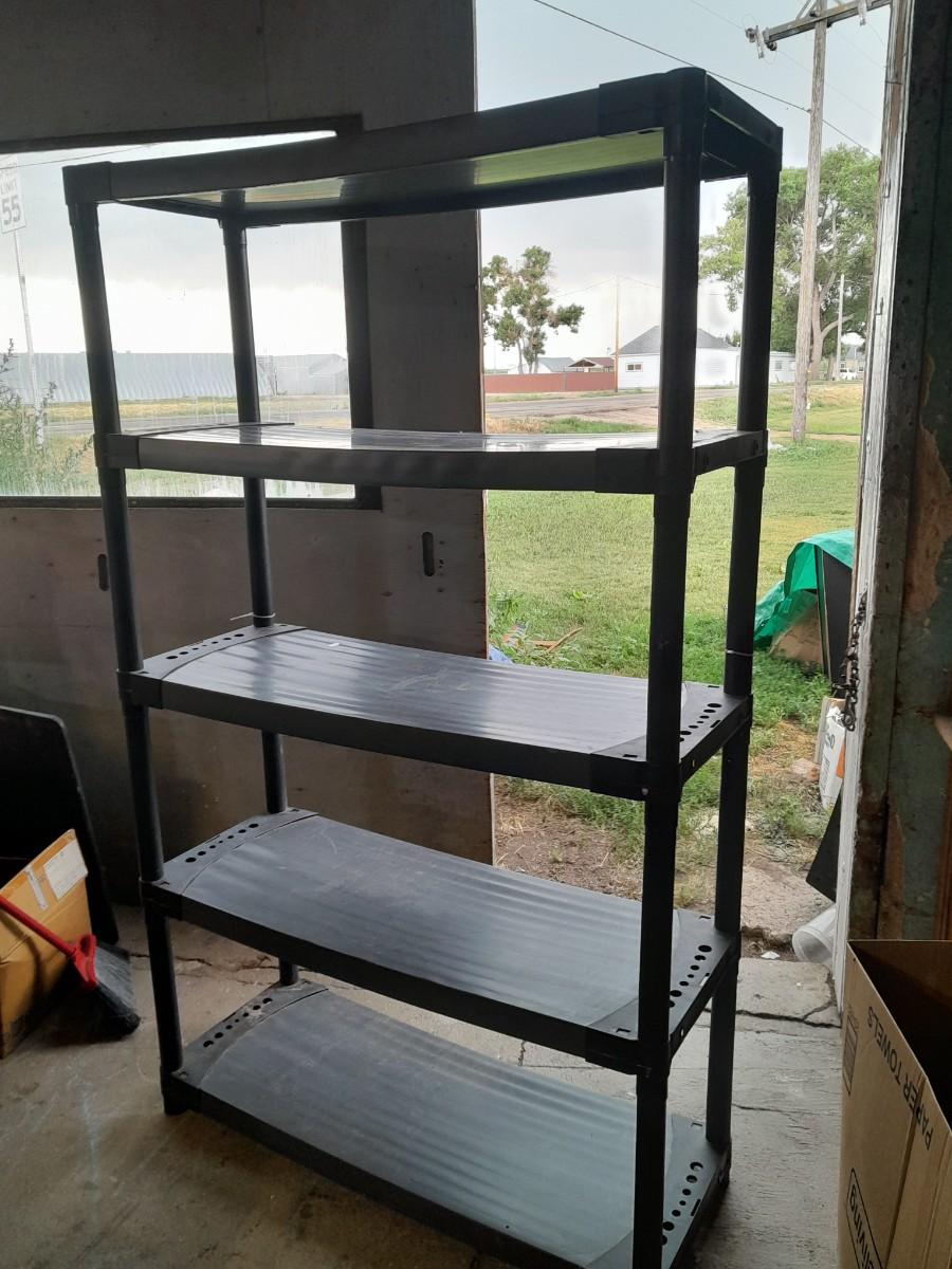 Tall black plastic Storage shelving unit | EstateSales.org