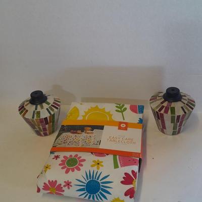 Two colored glass oil lamps with a new tablecloth
