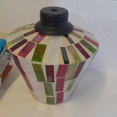 Two colored glass oil lamps with a new tablecloth