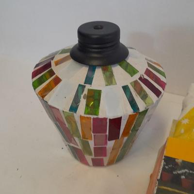 Two colored glass oil lamps with a new tablecloth