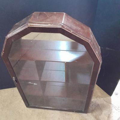 Black metal shelf and wall hanging wooden mirrored back display case.