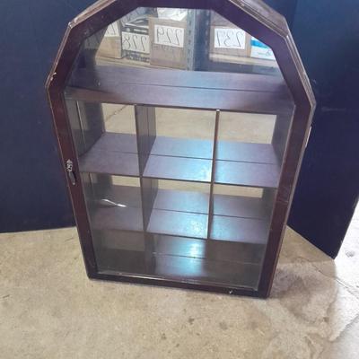Black metal shelf and wall hanging wooden mirrored back display case.