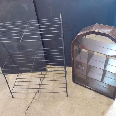 Black metal shelf and wall hanging wooden mirrored back display case.