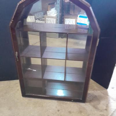 Black metal shelf and wall hanging wooden mirrored back display case.
