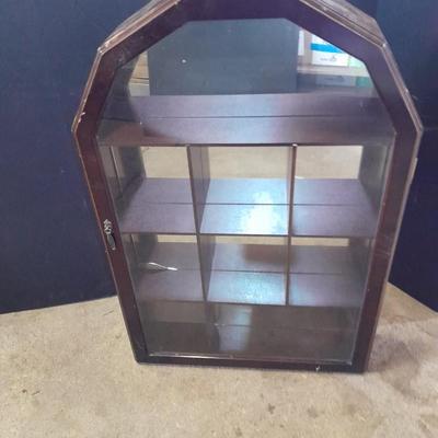 Black metal shelf and wall hanging wooden mirrored back display case.