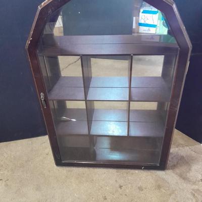 Black metal shelf and wall hanging wooden mirrored back display case.