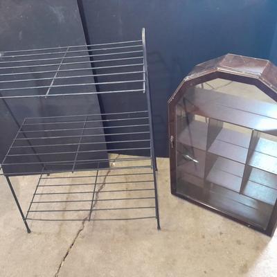 Black metal shelf and wall hanging wooden mirrored back display case.