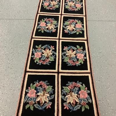 Black hooked rug with flowers, 8 rectangles creating this 5.10' x 2.3' rug