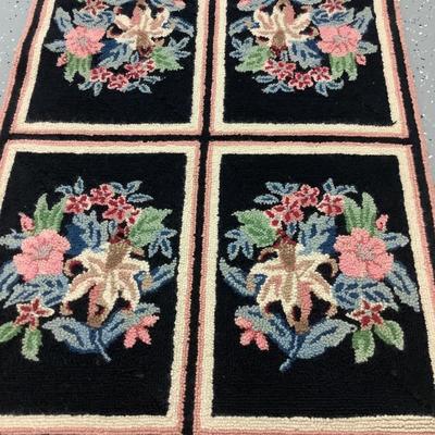 Black hooked rug with flowers, 8 rectangles creating this 5.10' x 2.3' rug