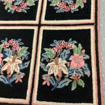 Black hooked rug with flowers, 8 rectangles creating this 5.10' x 2.3' rug
