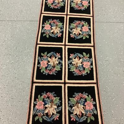 Black hooked rug with flowers, 8 rectangles creating this 5.10' x 2.3' rug