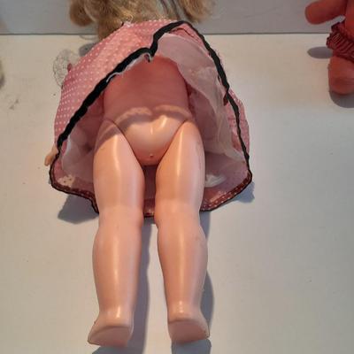 Plastic blonde doll with pig tails and Unknown brand Antique Kewpie like cloth with painted face doll