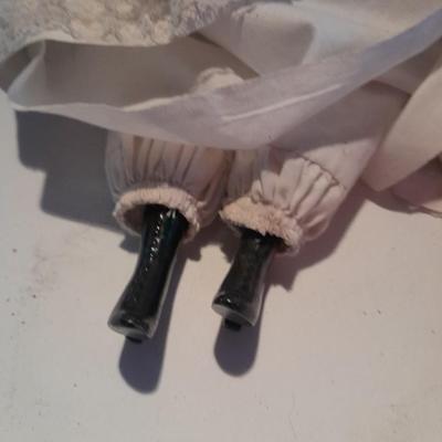 Three porcelain face and footed dolls Cloth bodied.