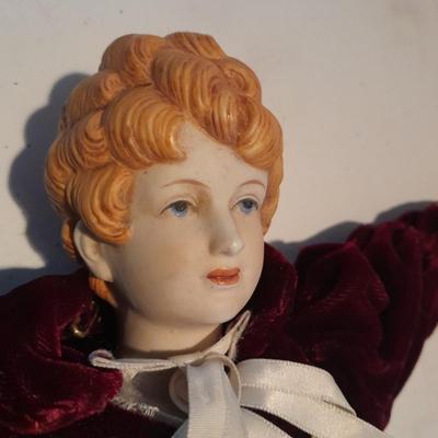 Three porcelain face and footed dolls Cloth bodied.