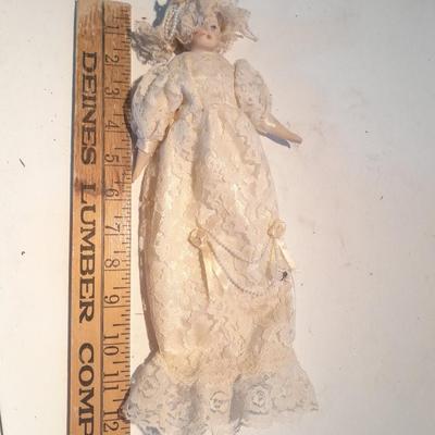 Three porcelain face and footed dolls Cloth bodied.