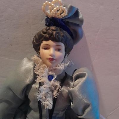 Three porcelain face and footed dolls Cloth bodied.