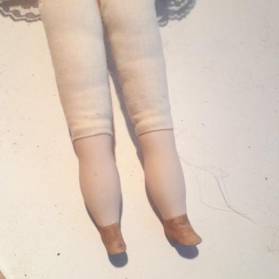 Three porcelain face and footed dolls Cloth bodied.