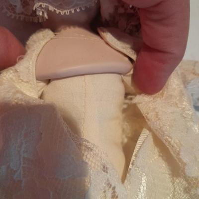 Three porcelain face and footed dolls Cloth bodied.