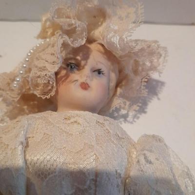 Three porcelain face and footed dolls Cloth bodied.