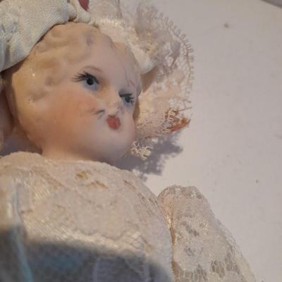 Three porcelain face and footed dolls Cloth bodied.