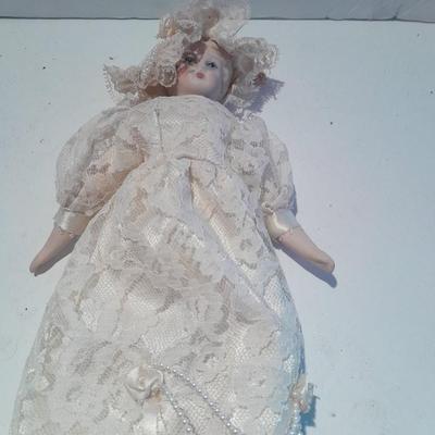 Three porcelain face and footed dolls Cloth bodied.